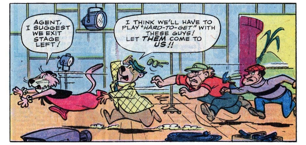 A panel from this issue showing two guys chasing Snagglepuss the lion and Yogi Bear through a television studio. Snagglepuss says, “Agent, I suggest we exit stage left!” Yogi says, “I think we’ll have to play ‘hard-to-get’ with these guys! Let them come to us!!”